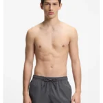 Quick-drying swim shorts with red logo label