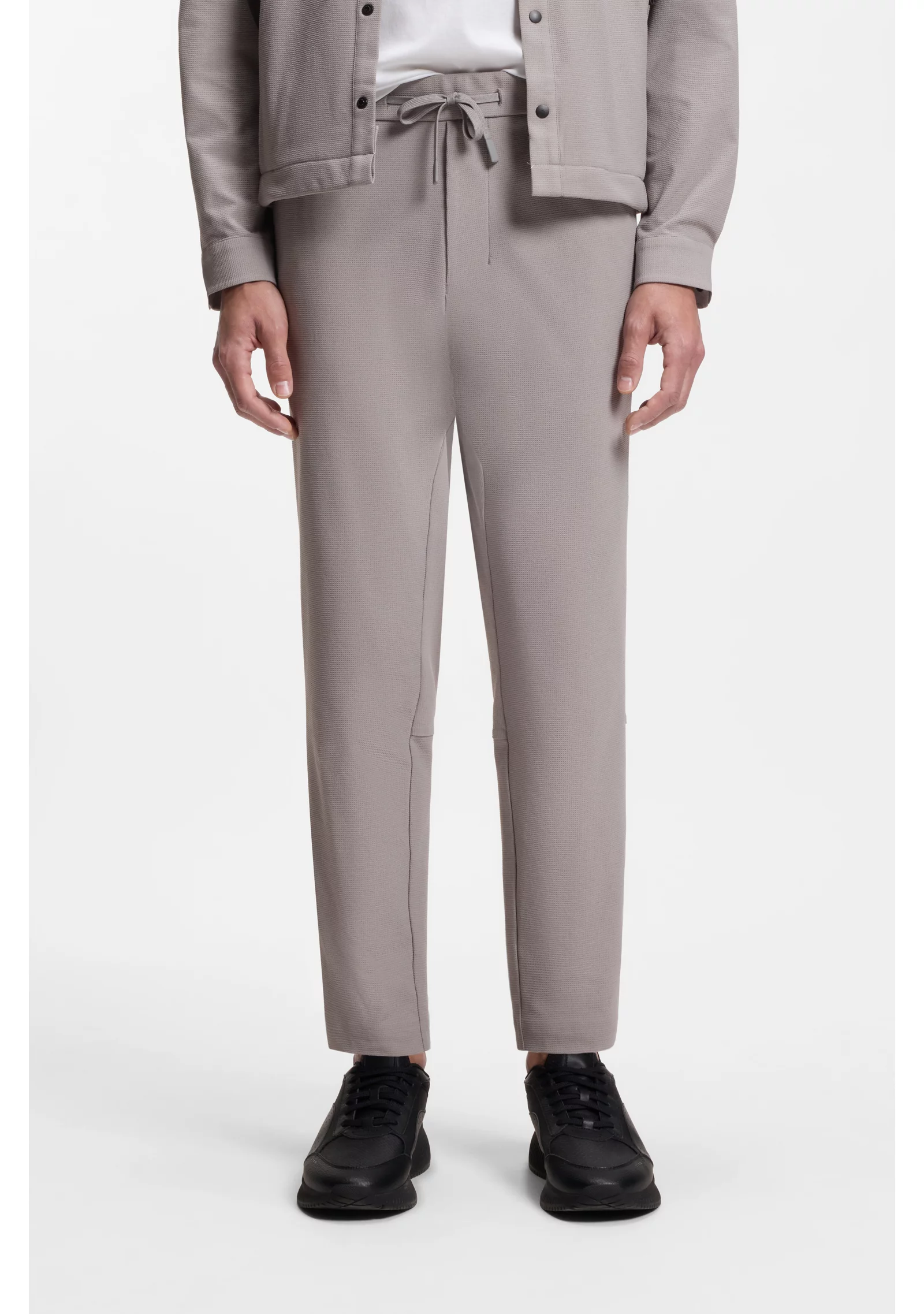 hbeu50551956_063_350 Tapered-fit trousers in waffle-structured stretch fabric - Image 1