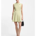 Sleeveless dress with gold-tone flower brooch